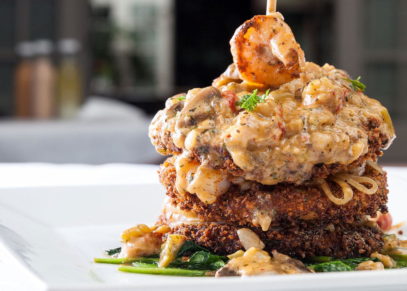 Shrimp and eggplant Napoleon stacked on a white plate at Morel's